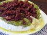 Brie Topped With Pesto and Sun-Dried Tomatoes