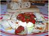 Brie Topped With Pesto and Sun-Dried Tomatoes