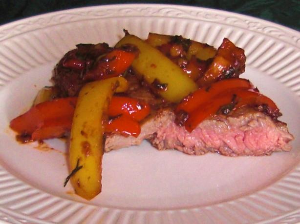 Steak Topped With Peppers and Onions. Photo by KateL