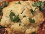 Whole Baked Cauliflower With Tomato and Olive Sauce. Photo by Irmgard