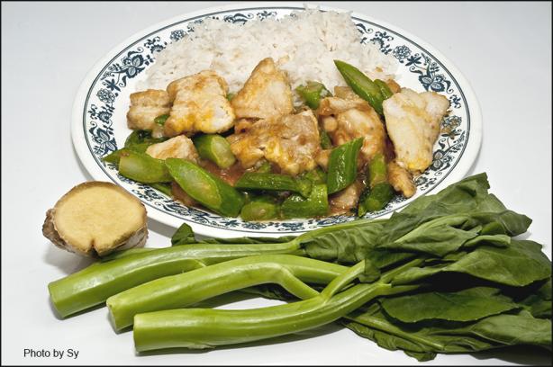 Sliced Fish With Chinese Broccoli on White Rice. Photo by Skipper/Sy